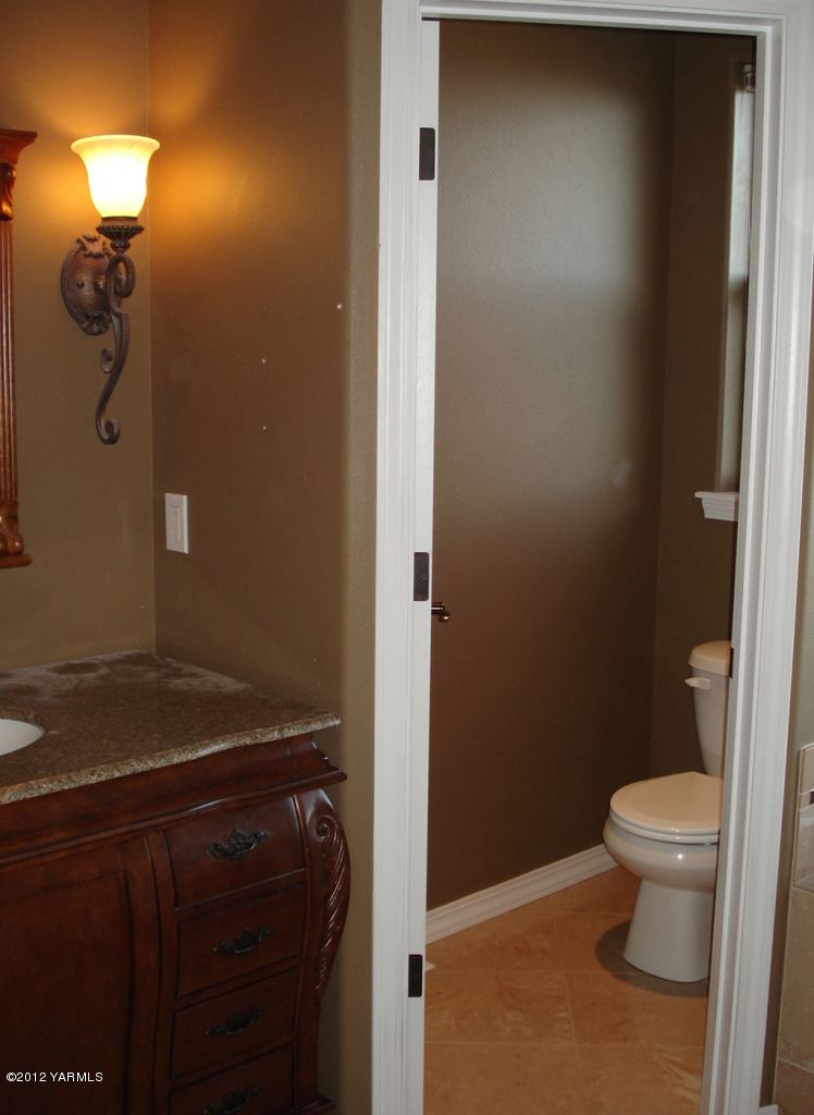 840 Dilley Road Tieton, WA 98947 - Photo 15 of 23 a bathroom with a granite countertop sink and toilet