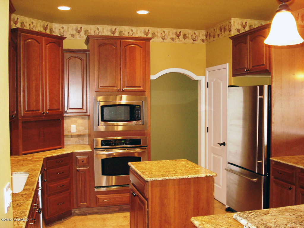 840 Dilley Road Tieton, WA 98947 - Photo 6 of 23 a kitchen with a refrigerator and a stove top oven