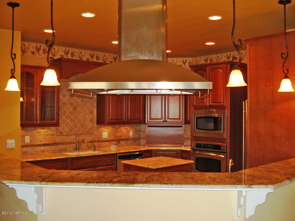 840 Dilley Road Tieton, WA 98947 - Photo 7 of 23 a kitchen with stainless steel appliances granite countertop a sink and a refrigerator