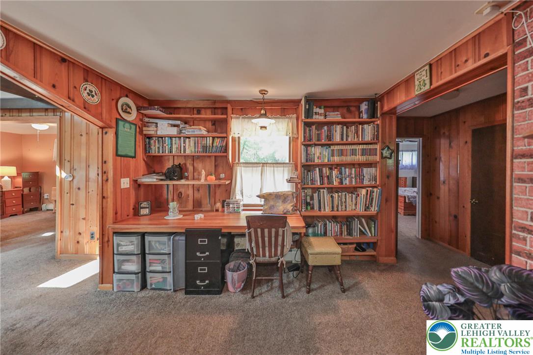 331 Cranberry Creek Road Cresco, PA 18326 - Photo 23 of 95 A dedicated home office provides ample built-in shelving for books and storage, fostering a productive environment.
