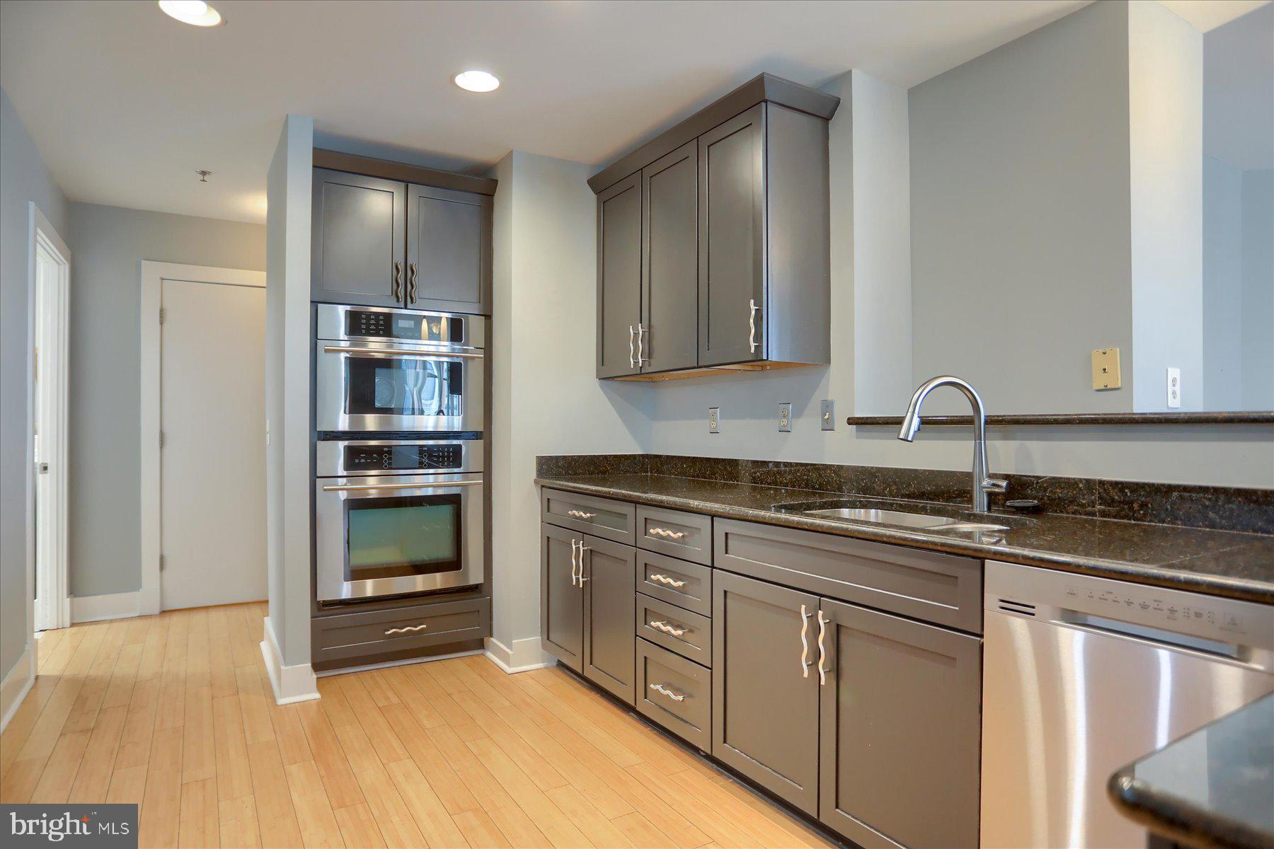1400 Lancaster Street, Unit 802 Baltimore, MD 21231 - Photo 13 of 34 a kitchen with stainless steel appliances granite countertop a sink and cabinets