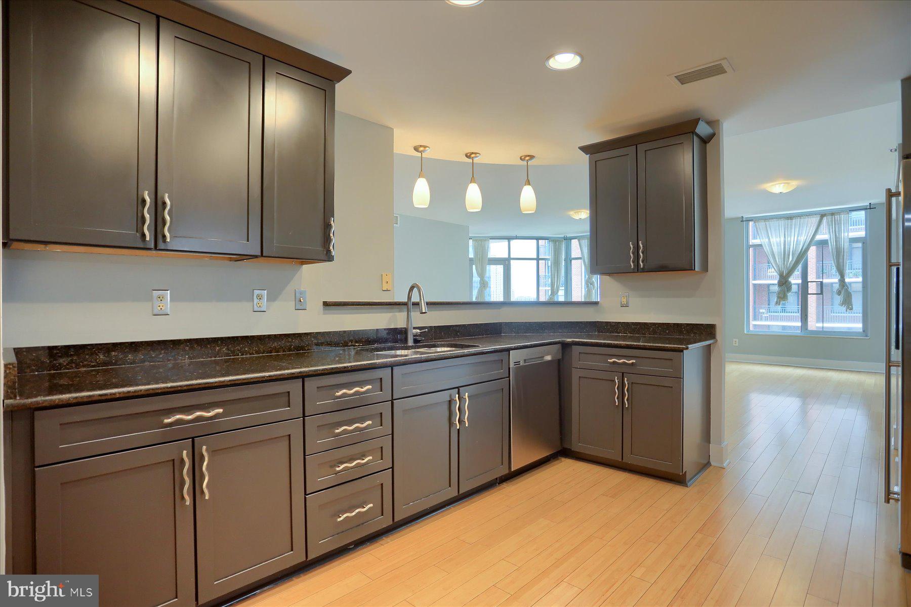 1400 Lancaster Street, Unit 802 Baltimore, MD 21231 - Photo 14 of 34 a kitchen with stainless steel appliances granite countertop a sink and cabinets