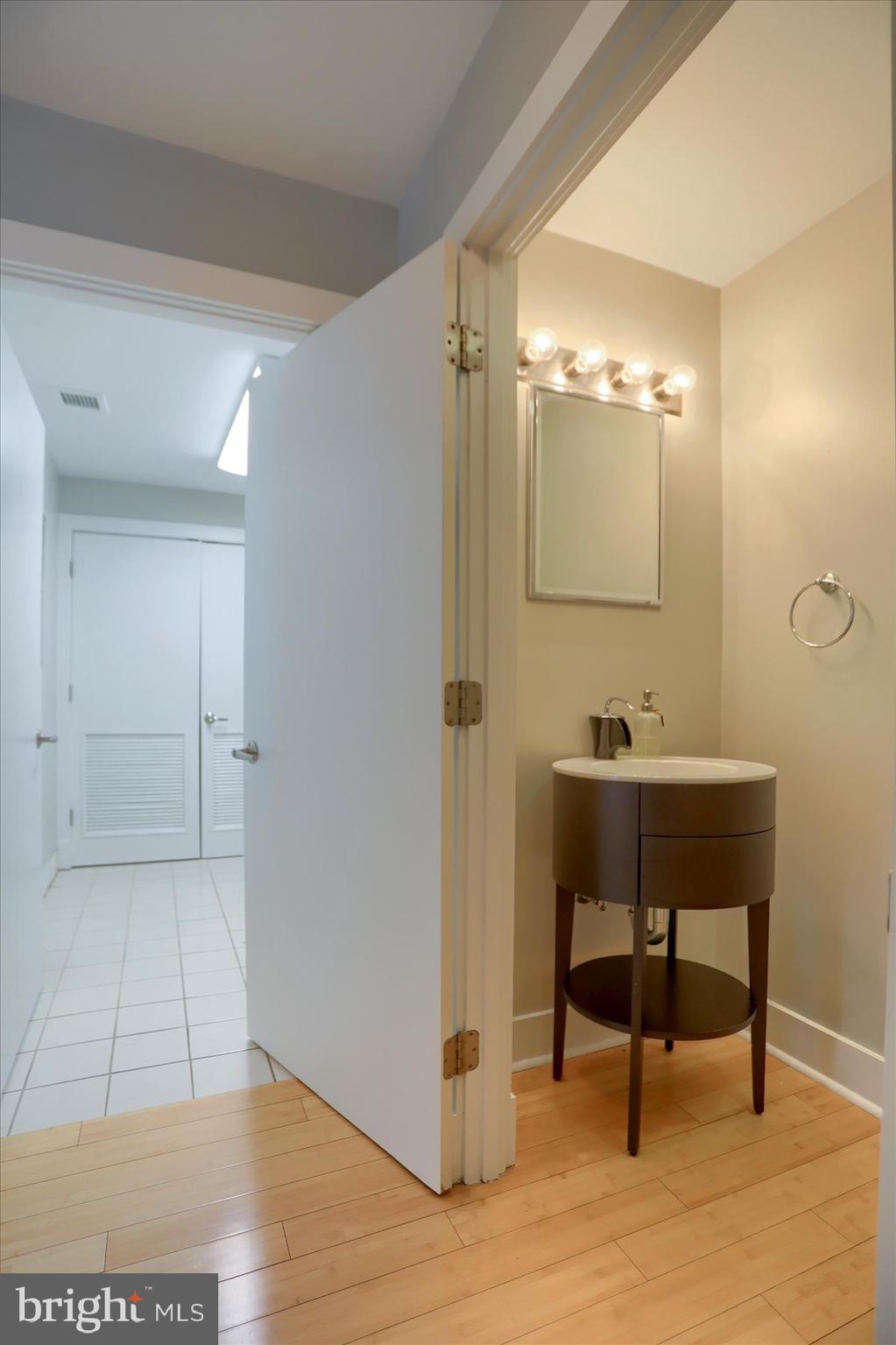 1400 Lancaster Street, Unit 802 Baltimore, MD 21231 - Photo 15 of 34 a bathroom with a sink and a mirror