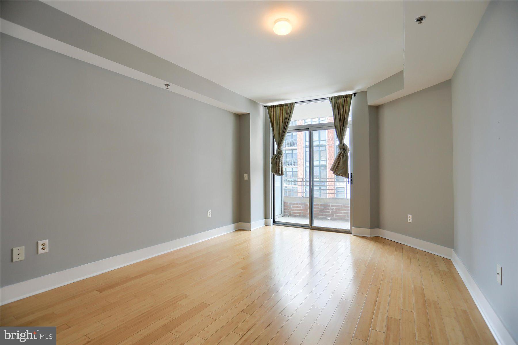 1400 Lancaster Street, Unit 802 Baltimore, MD 21231 - Photo 17 of 34 wooden floor in an empty room with a window