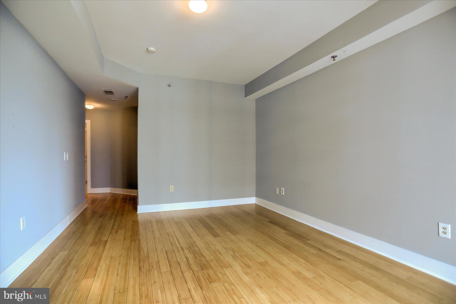 1400 Lancaster Street, Unit 802 Baltimore, MD 21231 - Photo 18 of 34 a view of an empty room with wooden floor