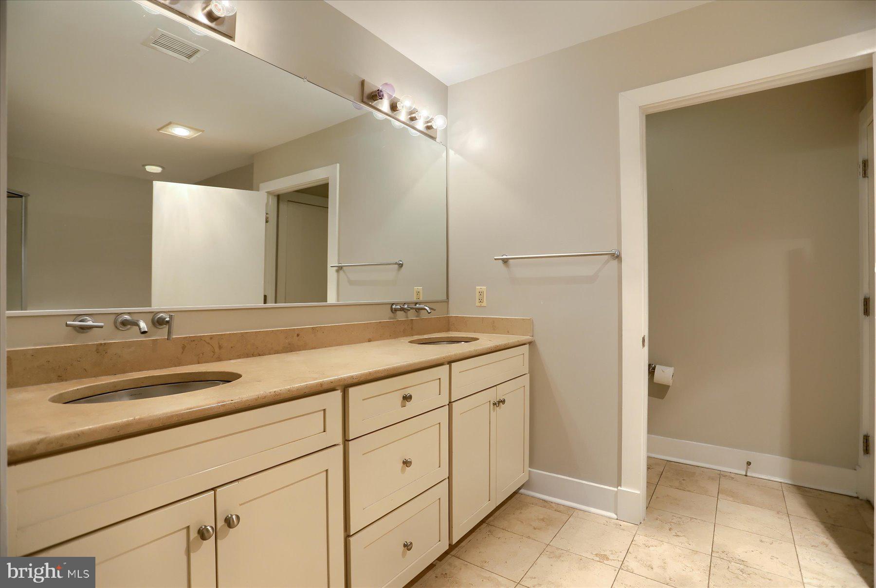 1400 Lancaster Street, Unit 802 Baltimore, MD 21231 - Photo 20 of 34 a bathroom with double sink and a mirror