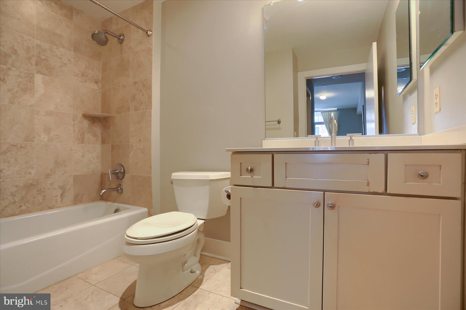 1400 Lancaster Street, Unit 802 Baltimore, MD 21231 - Photo 26 of 34 a bathroom with a toilet a sink and a bathtub