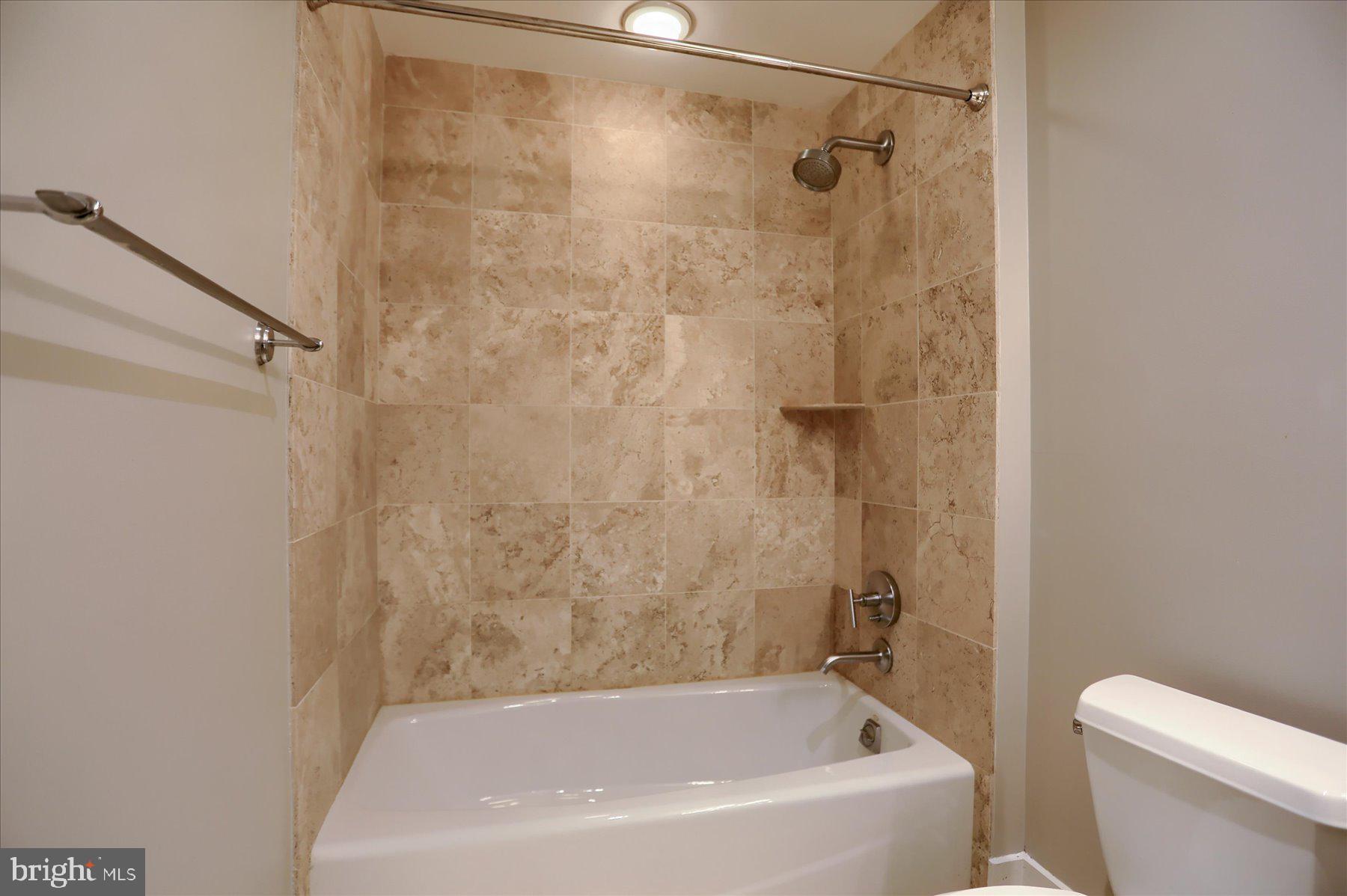 1400 Lancaster Street, Unit 802 Baltimore, MD 21231 - Photo 27 of 34 a bathroom with a bathtub and a shower