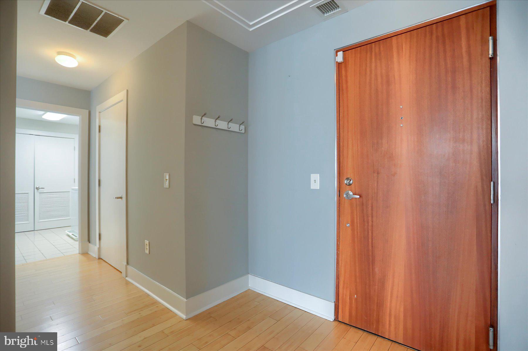 1400 Lancaster Street, Unit 802 Baltimore, MD 21231 - Photo 8 of 34 a view of a hallway with wooden floor