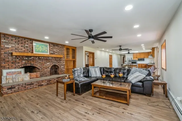 a living room with furniture wooden floor and a fireplace