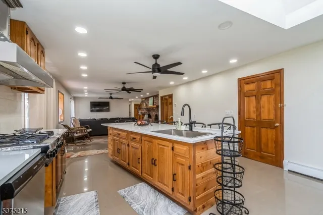 a kitchen with sink stove and cabinets
