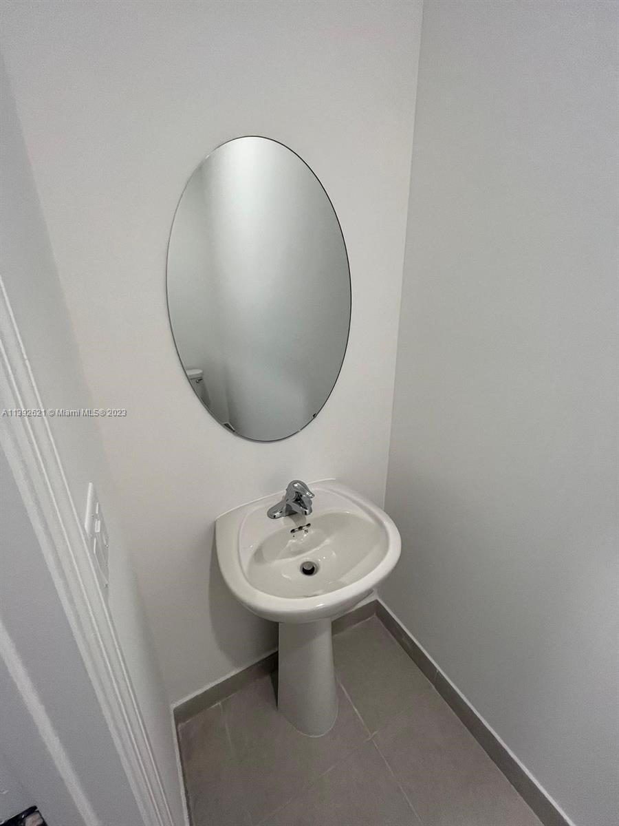 Miami-Dade County Homestead, FL 33032 - Photo 15 of 41 a bathroom with a sink and a mirror