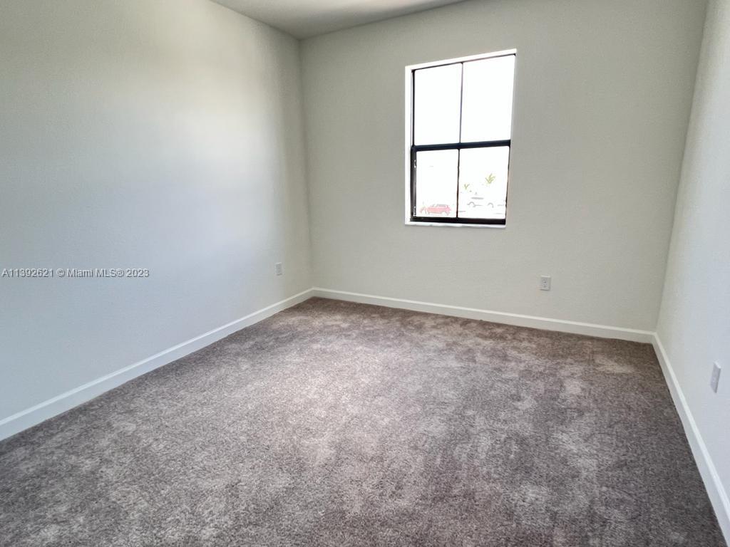 Miami-Dade County Homestead, FL 33032 - Photo 22 of 41 an empty room with a window
