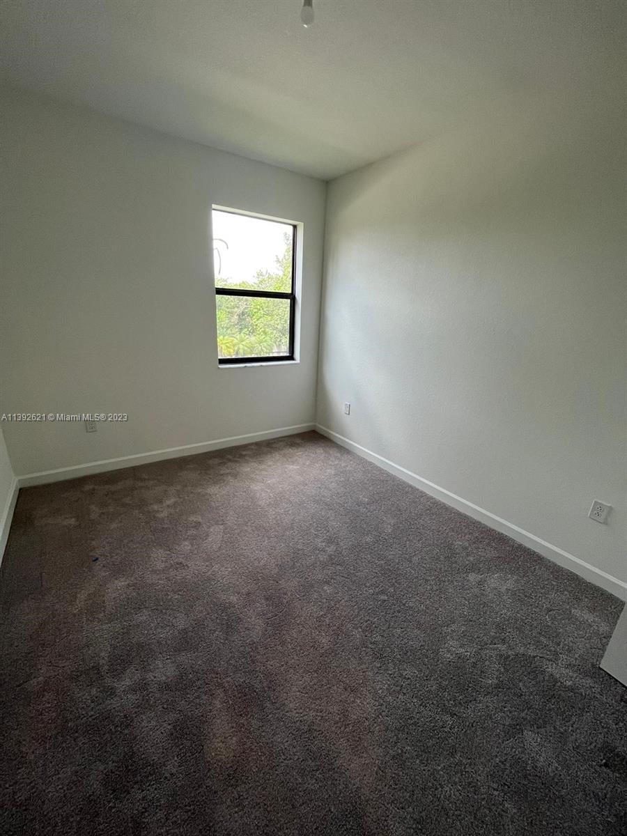 Miami-Dade County Homestead, FL 33032 - Photo 29 of 41 an empty room with a window