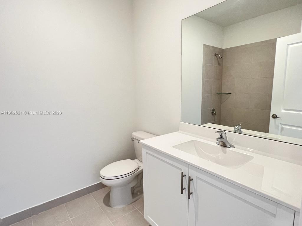 Miami-Dade County Homestead, FL 33032 - Photo 34 of 41 a bathroom with a sink a toilet and a mirror