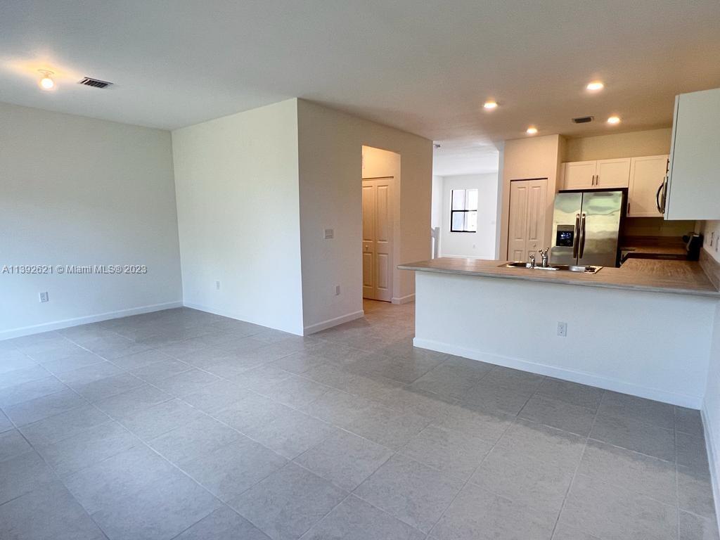 Miami-Dade County Homestead, FL 33032 - Photo 5 of 41 a view of a kitchen with a sink and cabinets