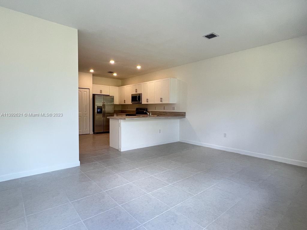 Miami-Dade County Homestead, FL 33032 - Photo 6 of 41 a view of a kitchen with a sink and microwave
