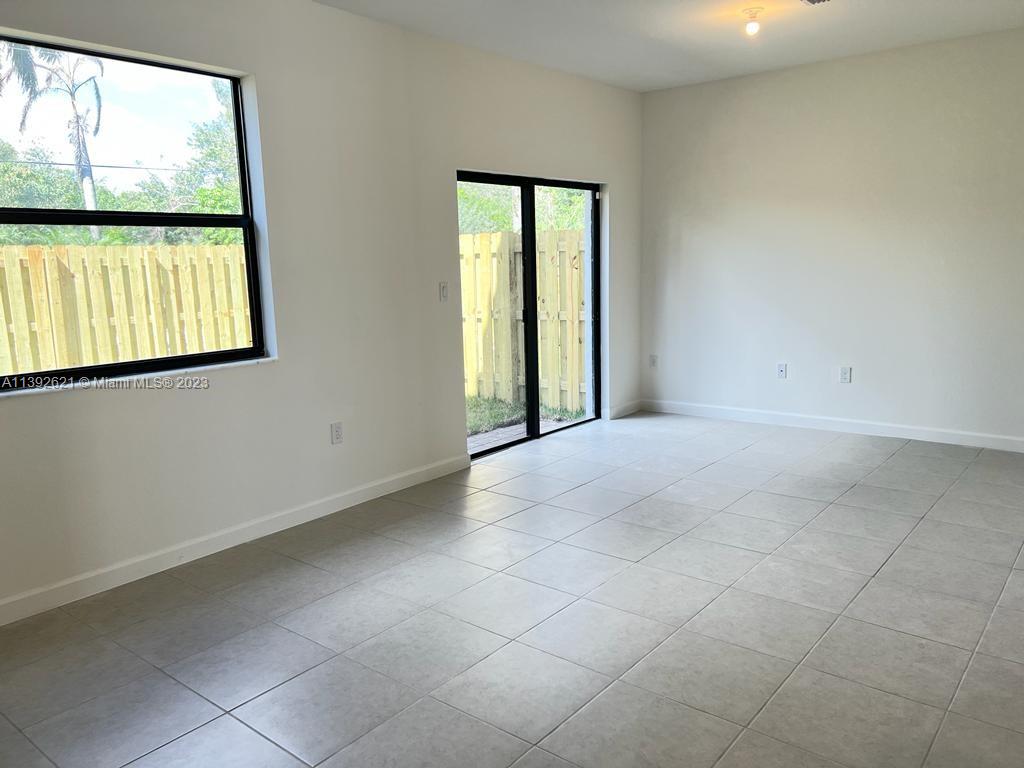 Miami-Dade County Homestead, FL 33032 - Photo 7 of 41 an empty room with large windows