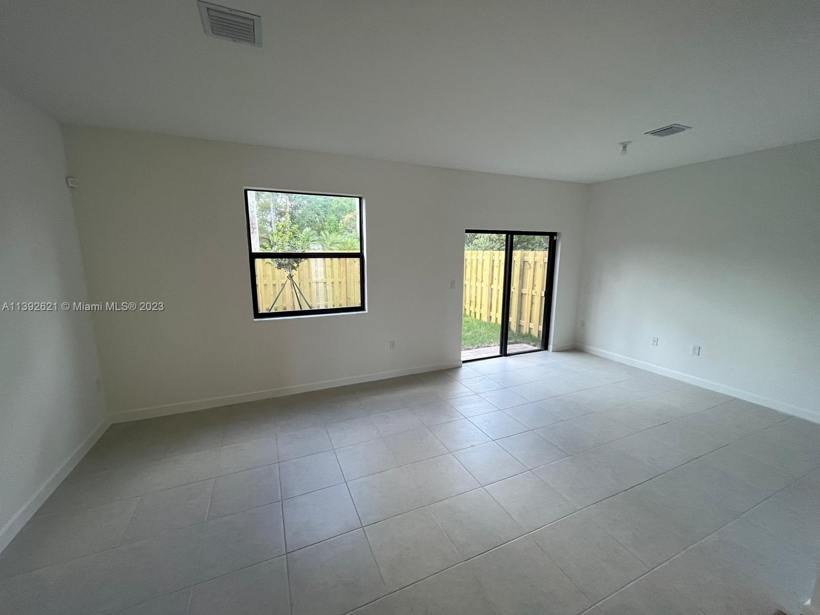 Miami-Dade County Homestead, FL 33032 - Photo 10 of 41 an empty room with windows