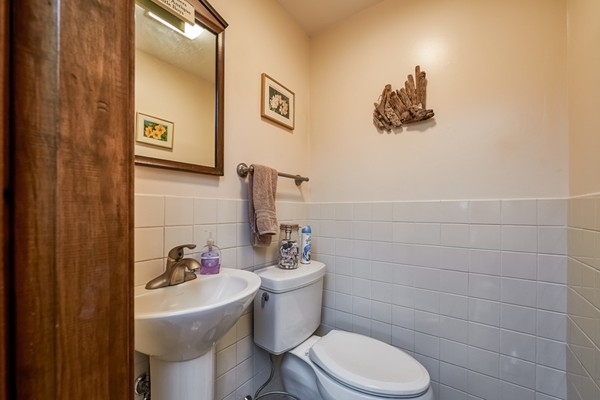 63 Johnson Street Boston, MA 02132 - Photo 11 of 13 a bathroom with a toilet sink and mirror