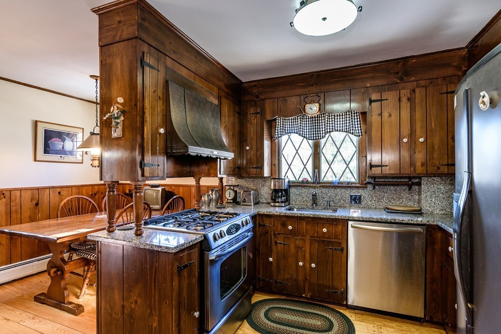 63 Johnson Street Boston, MA 02132 - Photo 5 of 13 a kitchen with a stove a sink and a refrigerator