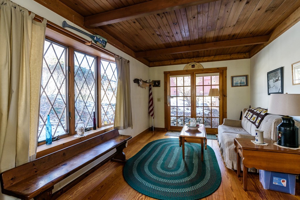 63 Johnson Street Boston, MA 02132 - Photo 6 of 13 a living room with furniture and a large window