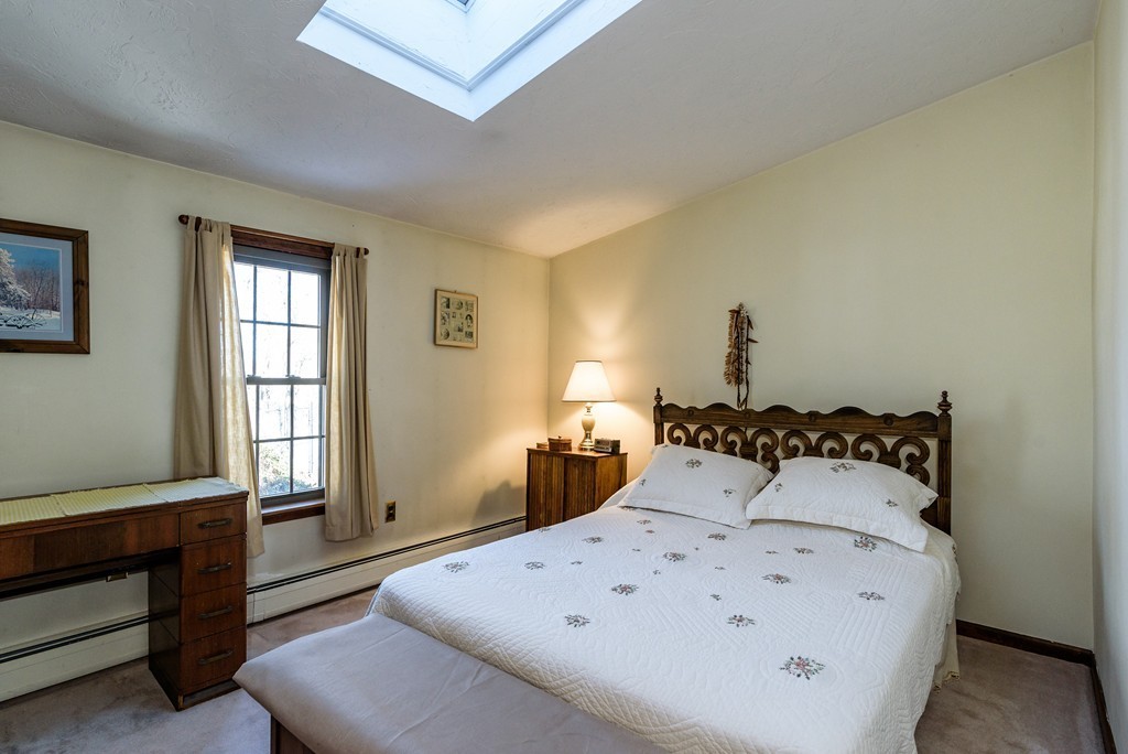 63 Johnson Street Boston, MA 02132 - Photo 9 of 13 a bedroom with a bed and a window