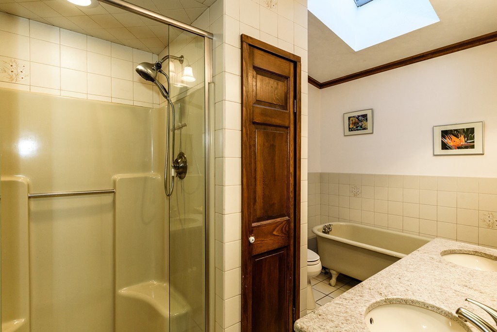 63 Johnson Street Boston, MA 02132 - Photo 10 of 13 a bathroom with a bathtub and shower