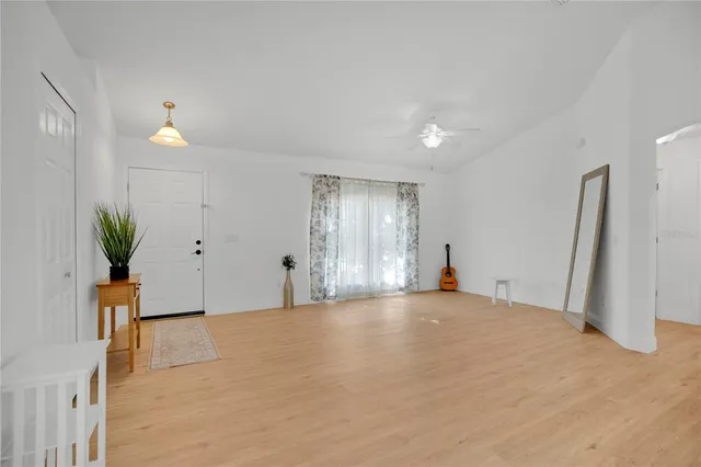 a view of a kitchen with wooden floor and a potted plant