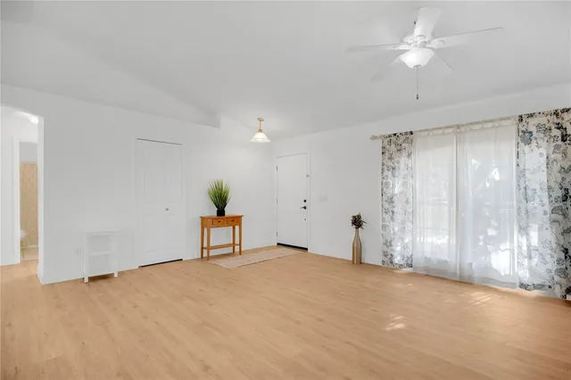 a view of empty room with wooden floor