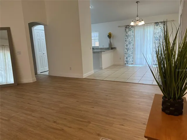 a view of a dining room with furniture and chandelier