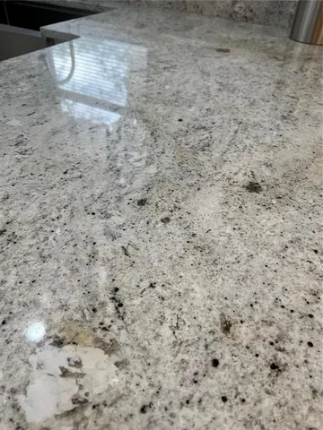 a room with a chandelier fan and a window