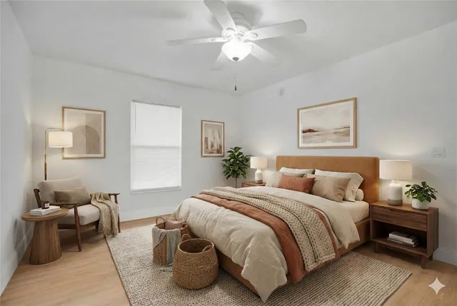 an empty room with wooden floor cabinet and windows