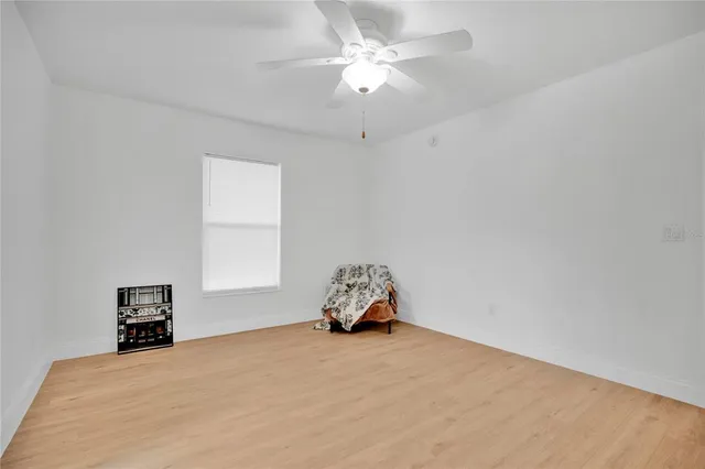 a view of an empty room and wooden floor