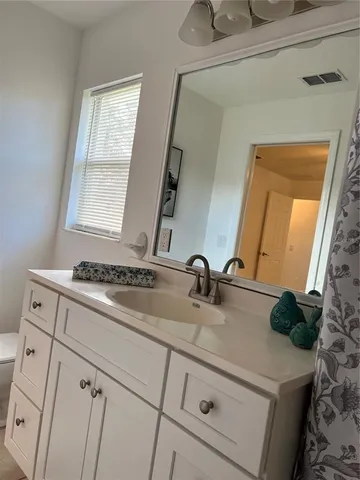 a view of a workspace with furniture and a potted plant