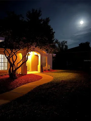 a view of an house with backyard space and balcony
