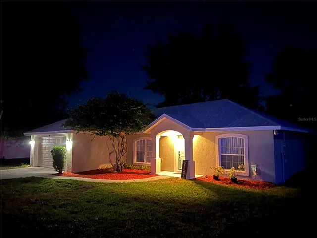 an aerial view of a house with garden space and street view