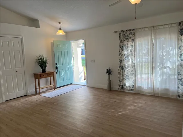 a bedroom with a bed and a chandelier fan