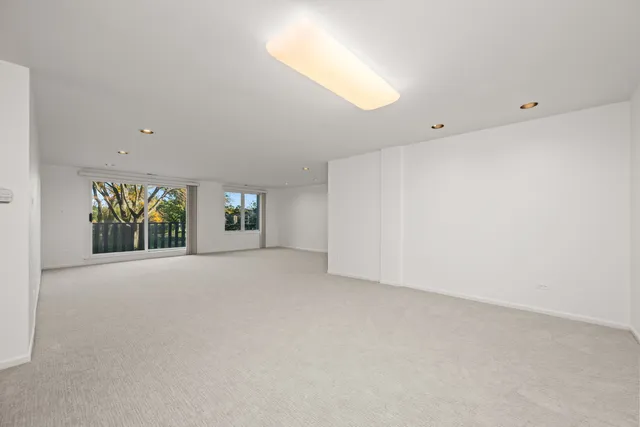 an empty room with windows and entrance