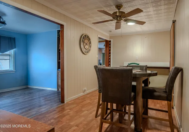 a view of a dining room with furniture and a chandelier fan
