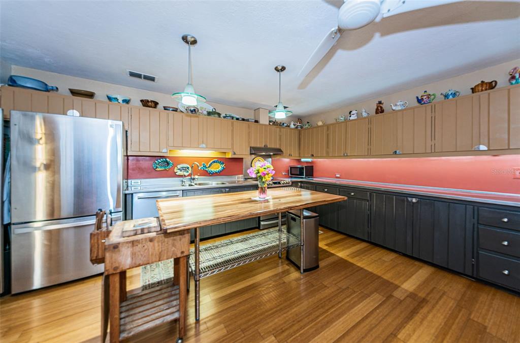 330 North Spring Boulevard Tarpon Springs, FL 34689 - Photo 13 of 34 a room with wooden floor pool table and chairs