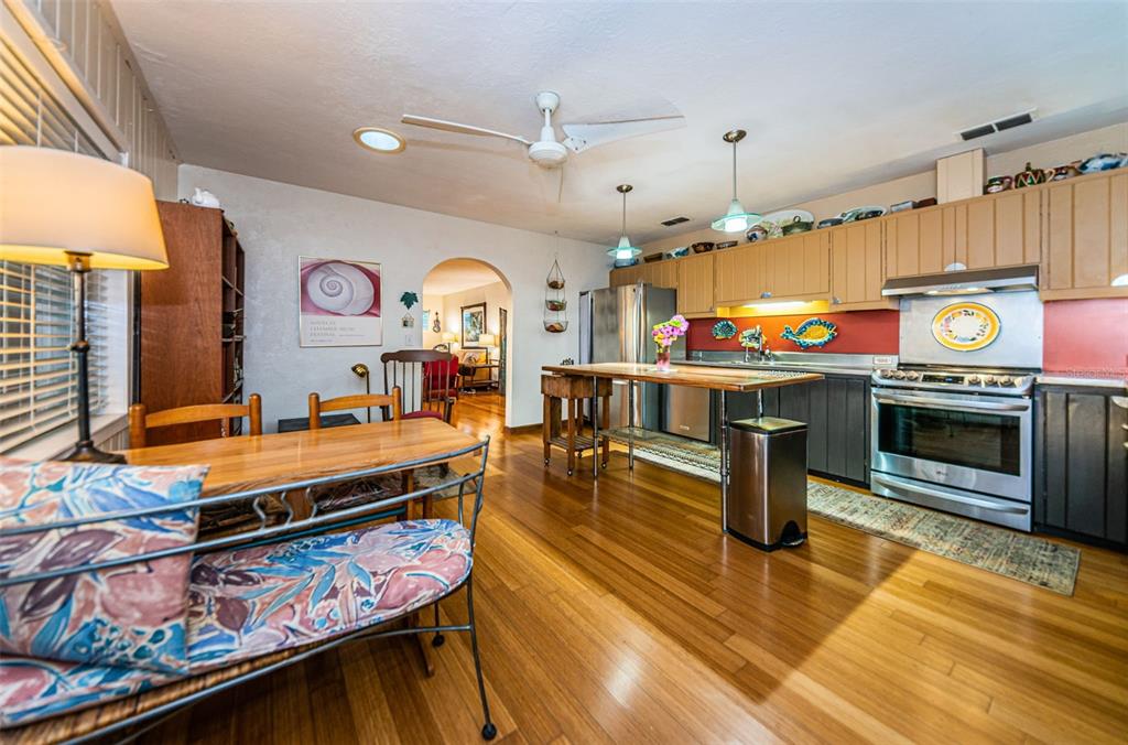 330 North Spring Boulevard Tarpon Springs, FL 34689 - Photo 14 of 34 a kitchen with stainless steel appliances kitchen island granite countertop a stove a sink and a microwave