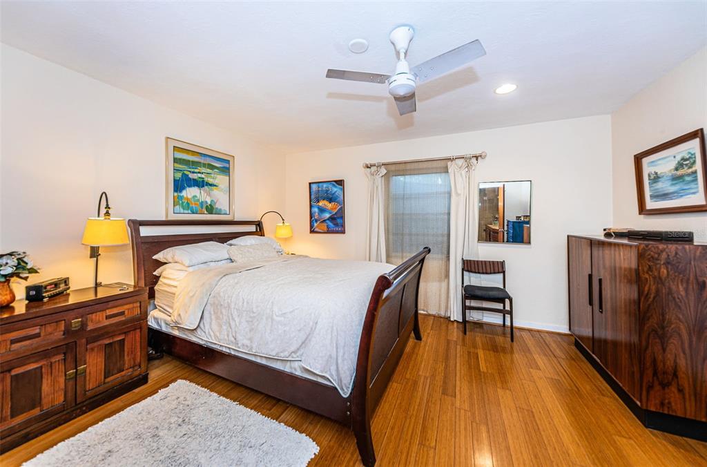 330 North Spring Boulevard Tarpon Springs, FL 34689 - Photo 19 of 34 a bedroom with a bed and wooden floor