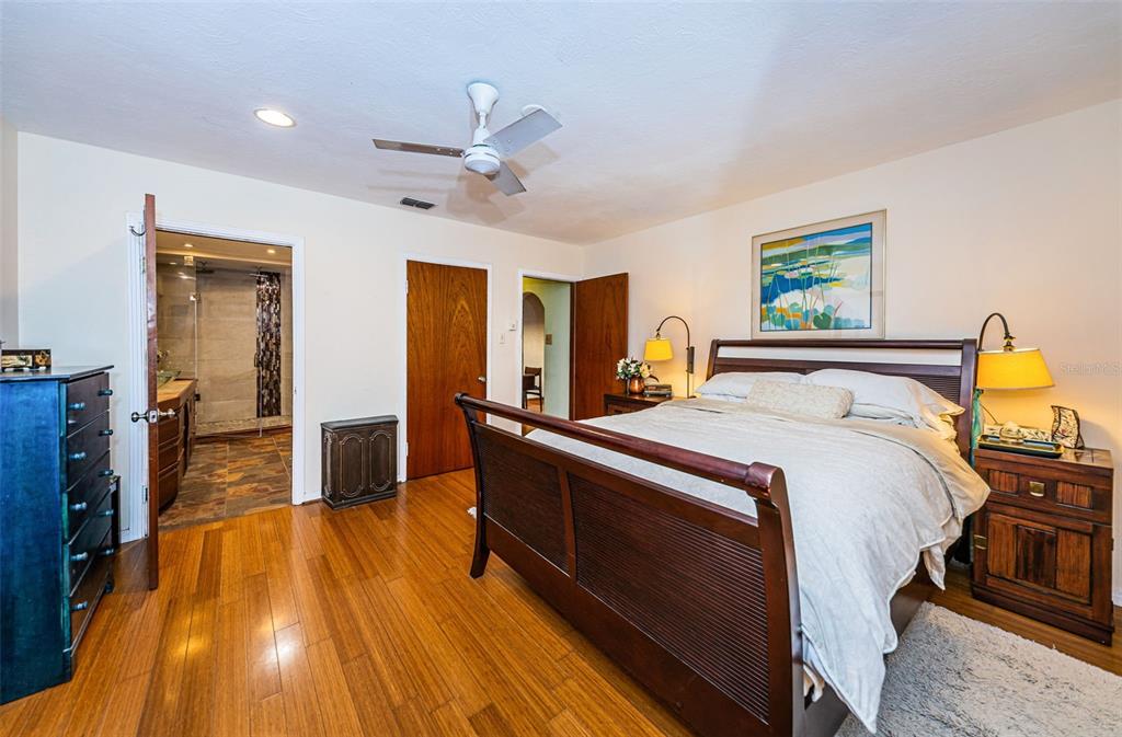 330 North Spring Boulevard Tarpon Springs, FL 34689 - Photo 20 of 34 a spacious bedroom with a bed and wooden floor