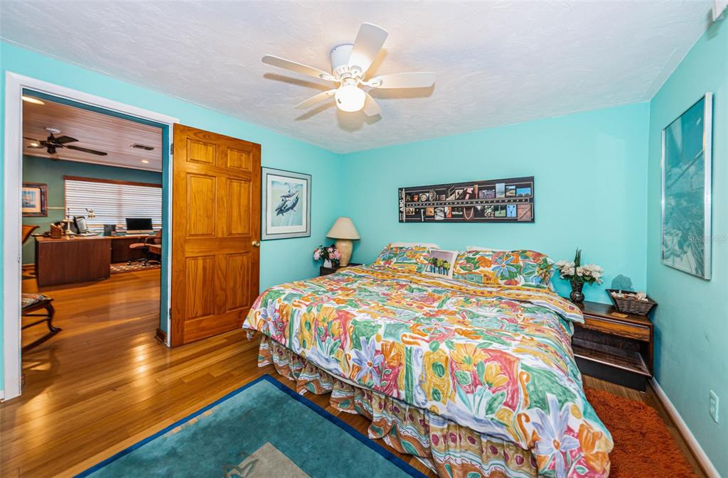 330 North Spring Boulevard Tarpon Springs, FL 34689 - Photo 23 of 34 a bedroom with a bed and a chandelier