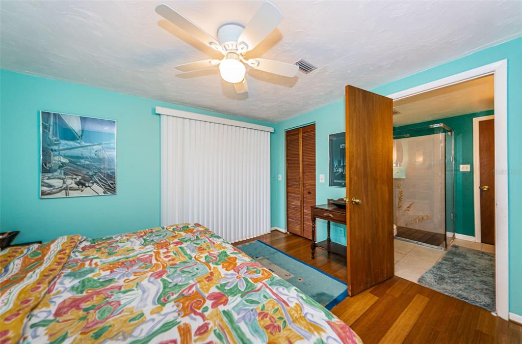 330 North Spring Boulevard Tarpon Springs, FL 34689 - Photo 24 of 34 a bedroom with a bed and a chandelier