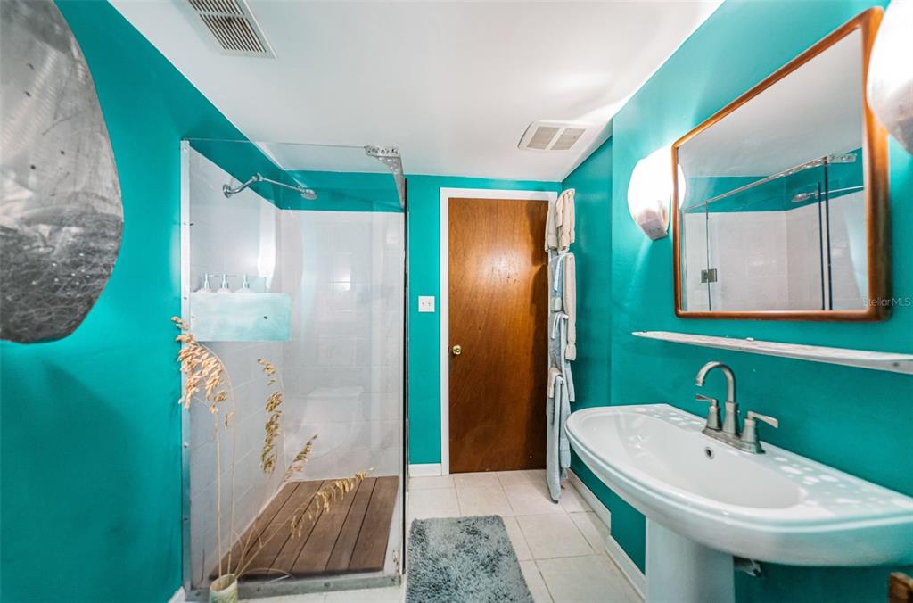 330 North Spring Boulevard Tarpon Springs, FL 34689 - Photo 25 of 34 a bathroom with a sink and a mirror