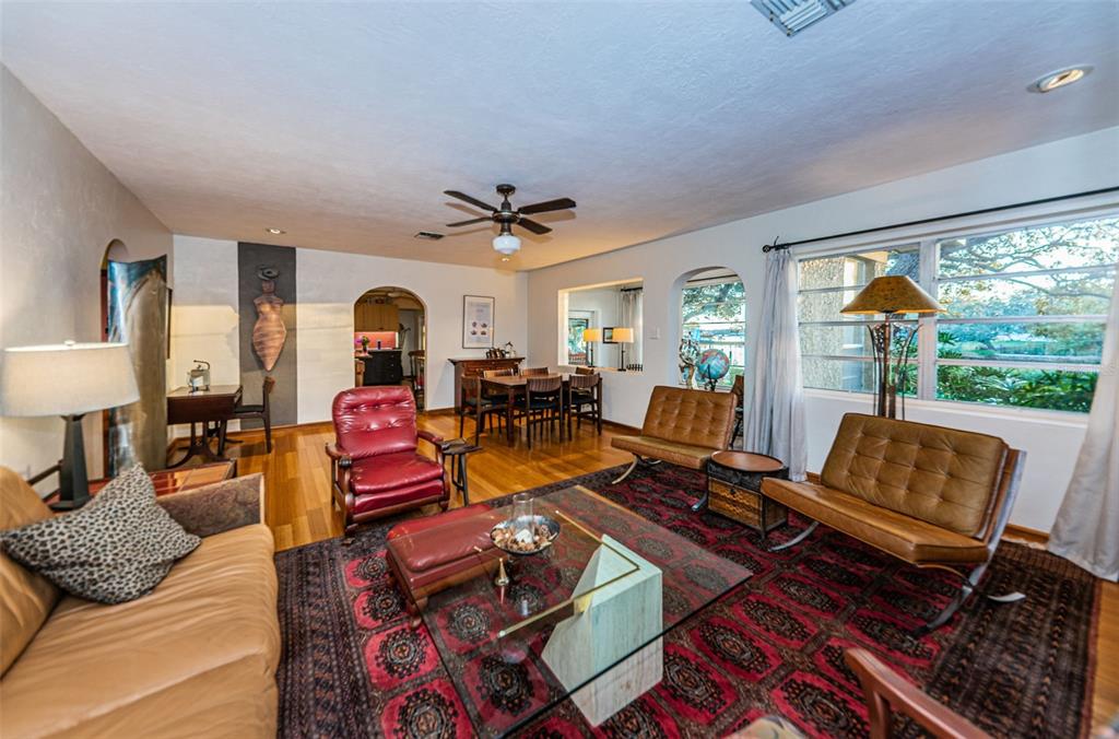 330 North Spring Boulevard Tarpon Springs, FL 34689 - Photo 9 of 34 a living room with furniture a fireplace and a large window