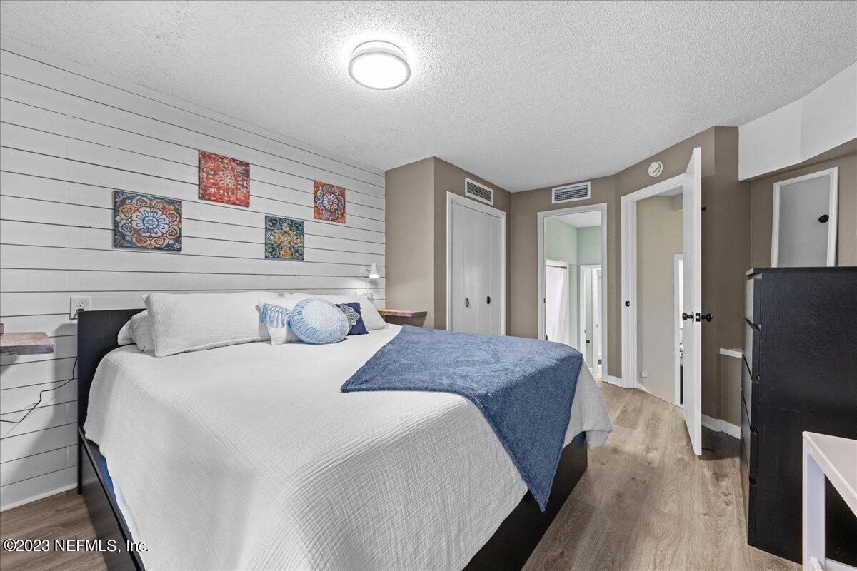 3155 Ravines Road, Unit 3522 Middleburg, FL 32068 - Photo 12 of 20 a bedroom with a bed and a refrigerator