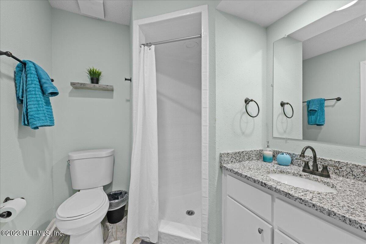 3155 Ravines Road, Unit 3522 Middleburg, FL 32068 - Photo 16 of 20 a bathroom with a granite countertop sink toilet and shower